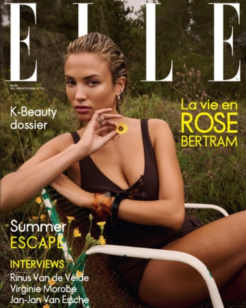 ELLE magazine cover featuring model Rose Bertram sitting outdoors in a black swimsuit, with large white ELLE lettering and yellow French cover text.